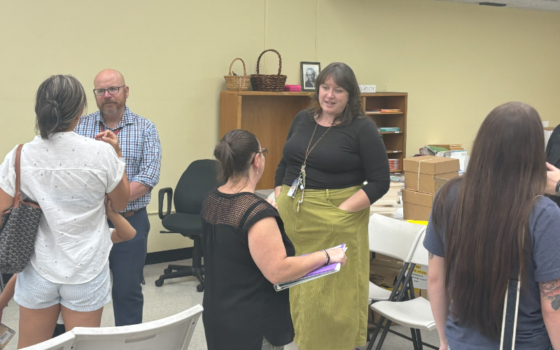 teachers and staff talking to new parents. 
